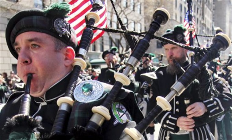 Joseph O'Keefe, left, plays a bagpipe as the Department of Sanitation of New York's Emerald Society Pipes and Drums marches during the St. Patrick's Day parade in New York last year.